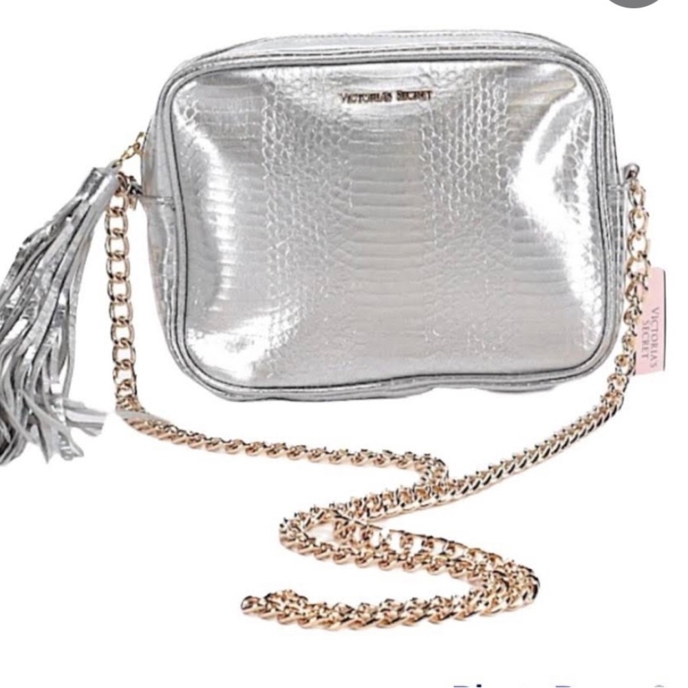 Victoria’s Secret metallic silver, crossbody bag with silver tassel zipper pull.